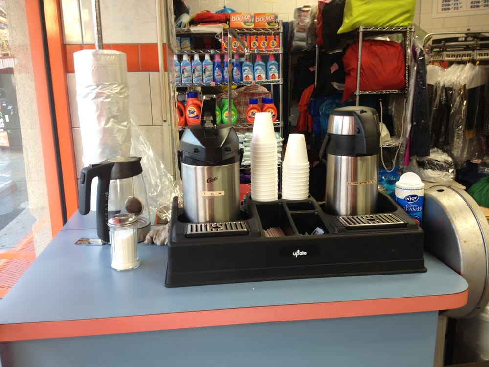 Detergent shelf and coffee station inside the Laundry King self-service laundromat in Brooklyn