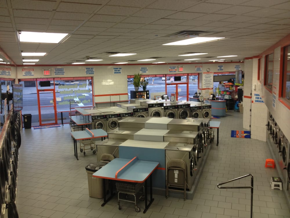 Folding tables and storefront windows inside the Laundry King laundromat in Sheepshead Bay Brooklyn