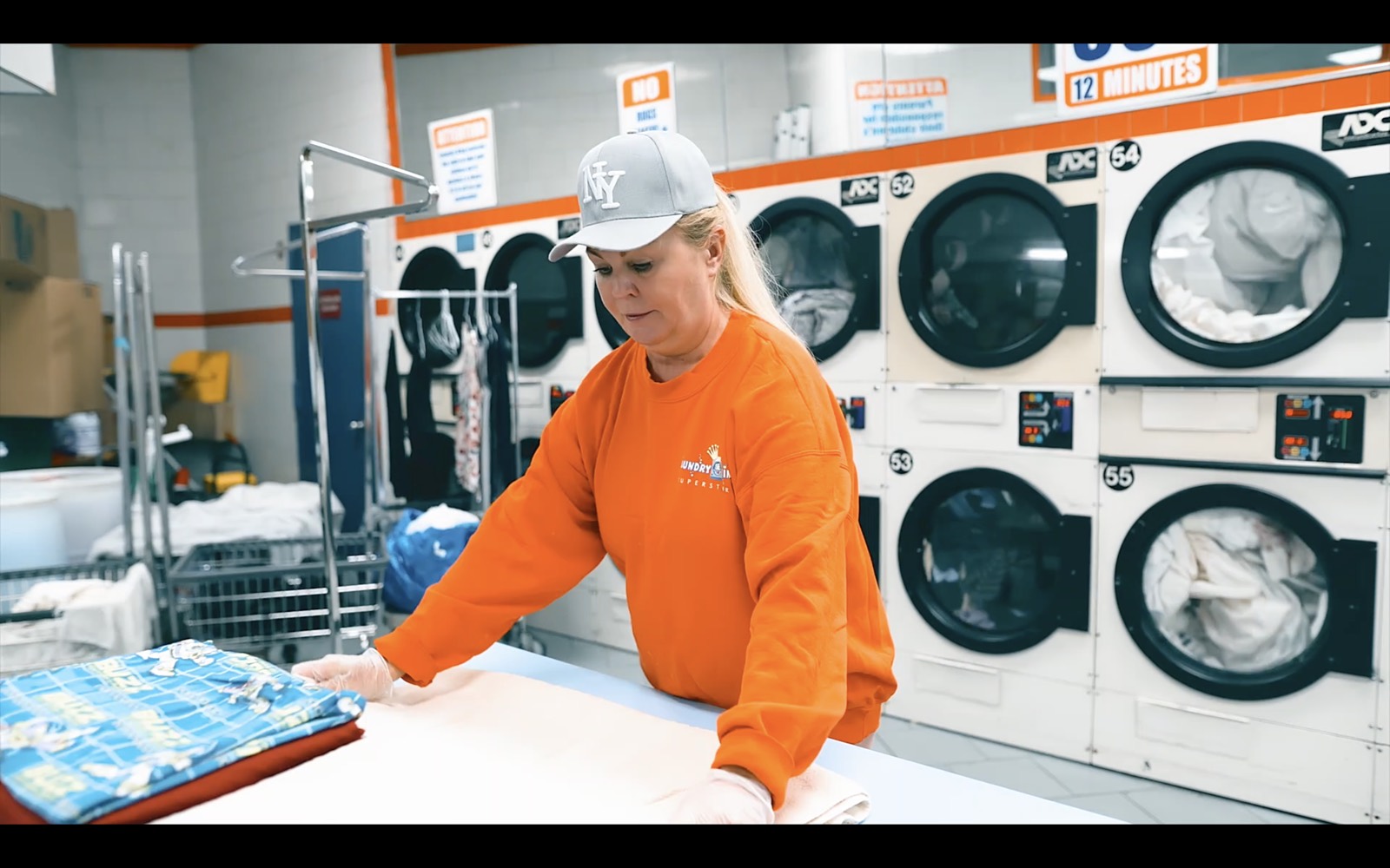 A Laundry King team member sorting customer laundry before washing at the Brooklyn shop